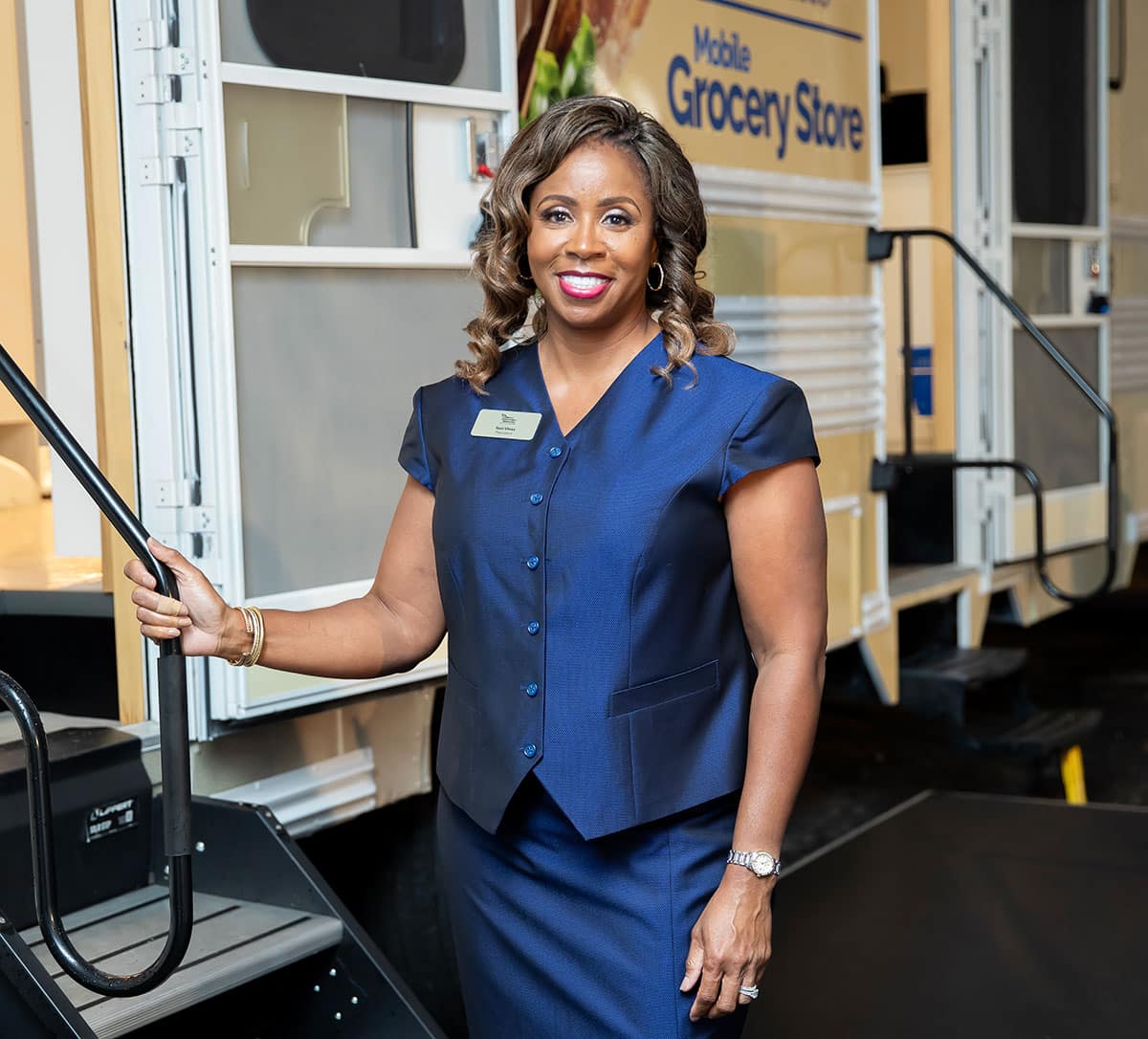 Toni Vines Standing Beside MDM's Mobile Grocery Bus